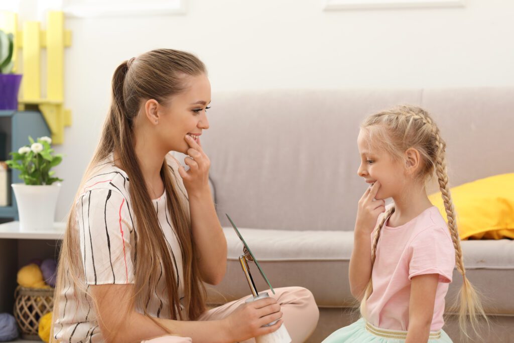 Woman who wants to getting into SLP graduate school helping a little girl