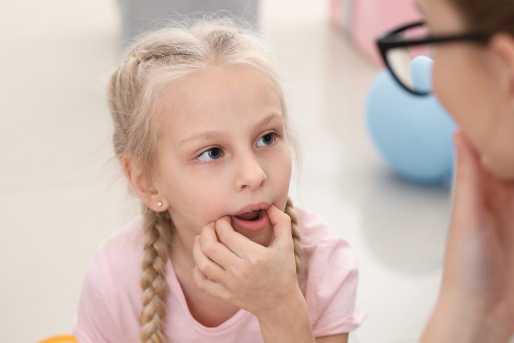 a child learning with a speech-language pathology professional