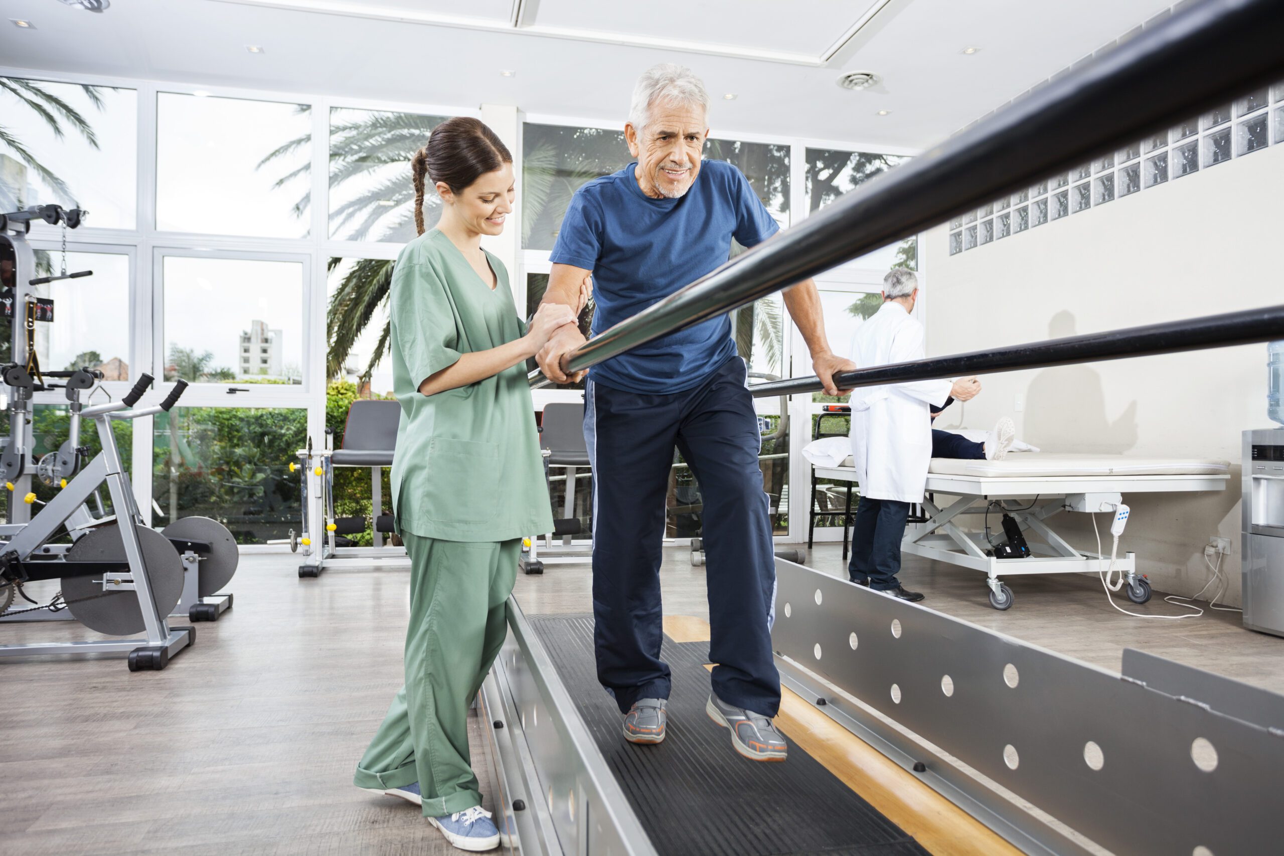 a physical therapist assisting an elderly patient