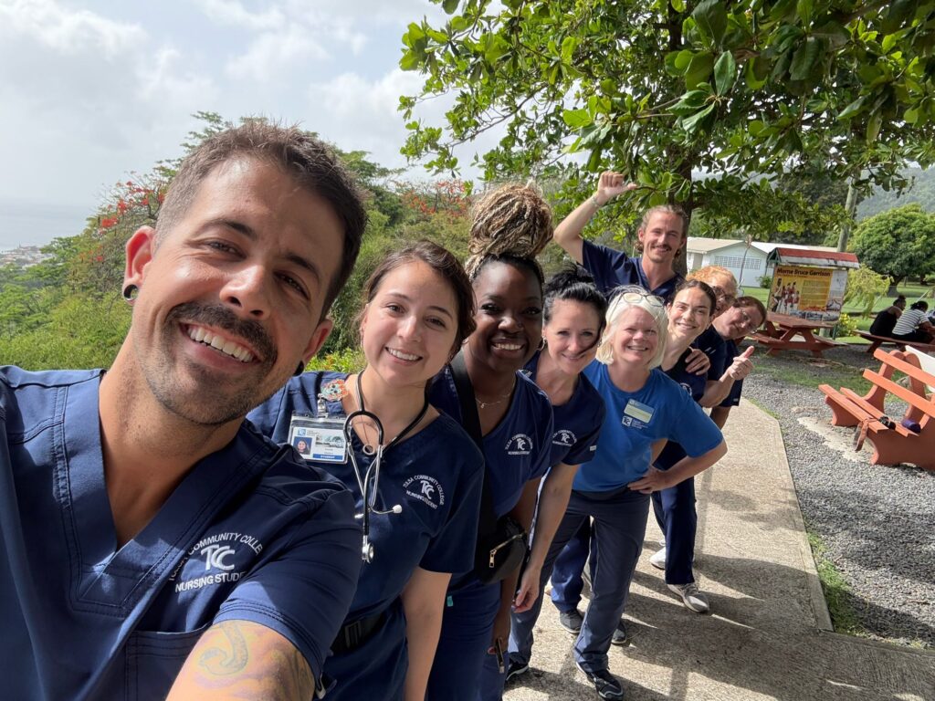 A group wearing scrubs walks together outdoors.