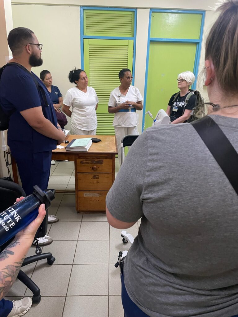 A group meets inside a village clinic.