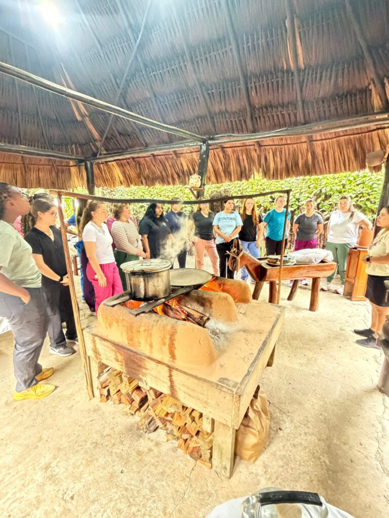 Participants join a cooking activity in an open-air setting.