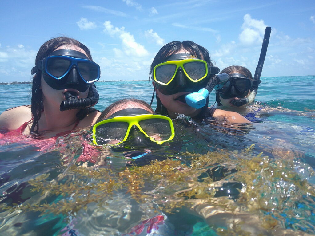 Participants wear snorkeling masks in the sea.