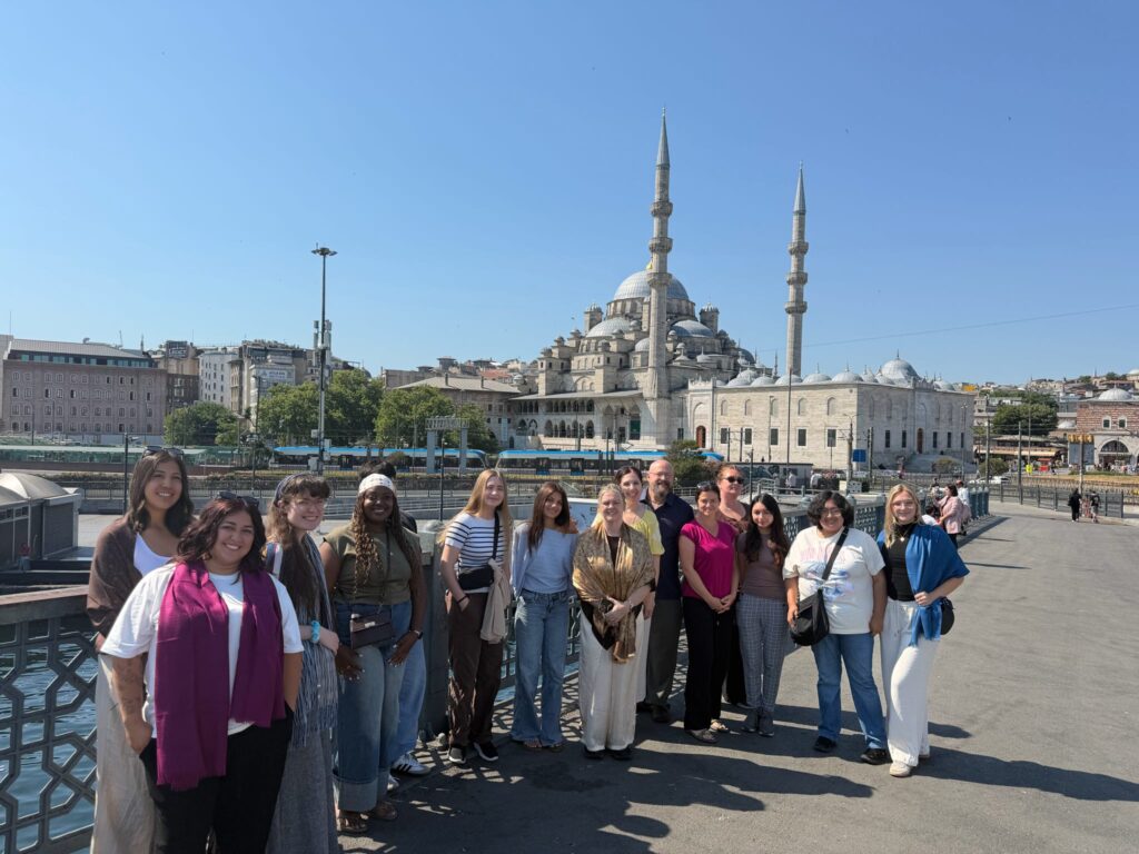 A group stands beside the waterfront in Istanbul.