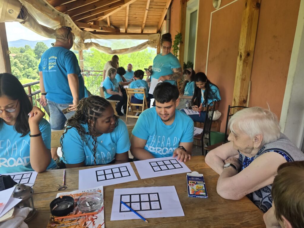 Participants play a tabletop game with older adults.